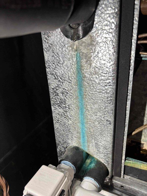 Responded to service call regarding water accumulation in furnace drain pan following previous day's furnace and water heater installation. Upon arrival, inspected both newly installed Bradford water heater and Carrier furnace system to identify source of moisture. Examined all refrigerant line connections, condensate drain routing, and surrounding insulation for potential leaks or condensation issues. Photographed HVAC components including insulated refrigerant lines, connection points, and drain pan area for documentation. Verified proper installation of flexible connections, shut-off valves, and insulated ductwork. Assessed drainage system functionality and confirmed no active leaks present at time of inspection.