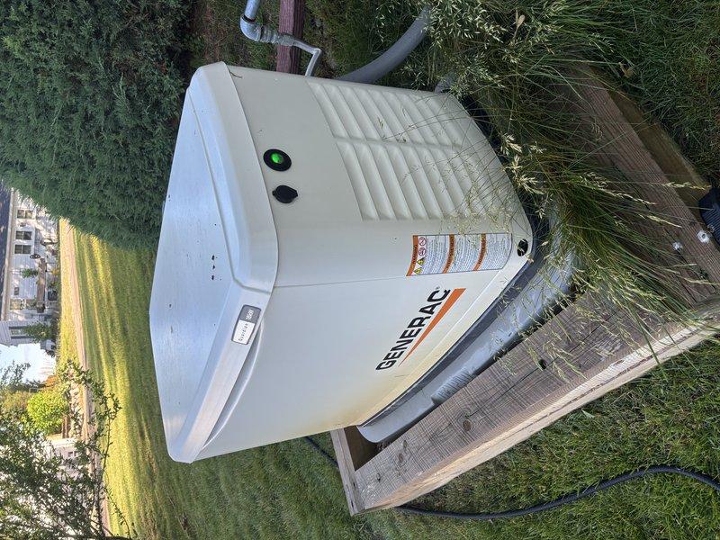 Completed annual preventative maintenance inspection on Generac Guardian 18kW standby generator unit. Performed comprehensive system evaluation including visual inspection of exterior housing, control panel functionality verification, and documentation of unit condition. Generator found in operational status with normal wear consistent with age, maintaining proper positioning on concrete pad with appropriate clearances from surrounding structures and landscaping.