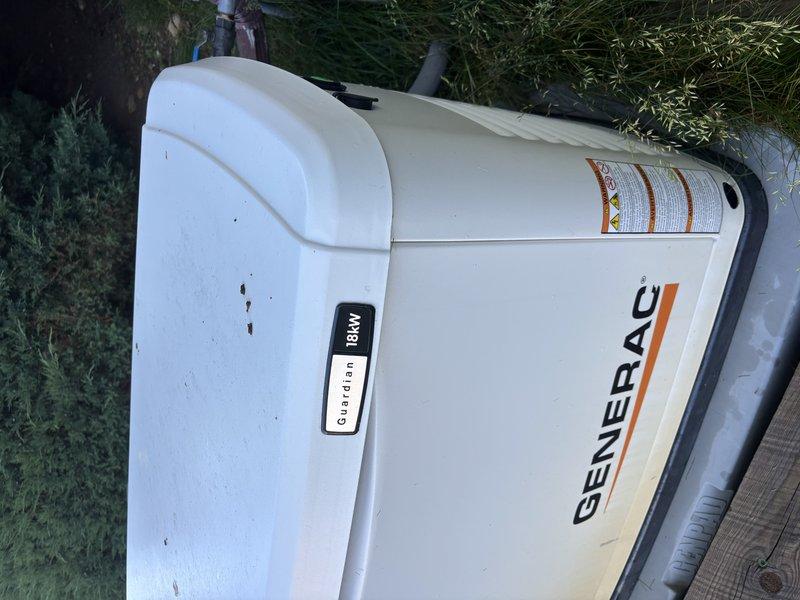 Completed annual preventative maintenance inspection on Generac Guardian 18kW standby generator unit. Performed comprehensive system evaluation including visual inspection of exterior housing, control panel functionality verification, and documentation of unit condition. Generator found in operational status with normal wear consistent with age, maintaining proper positioning on concrete pad with appropriate clearances from surrounding structures and landscaping.