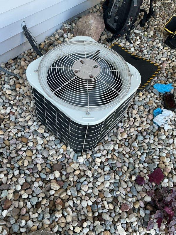 Completed comprehensive ASTU-AC Super Tune-up on 23-year-old Bryant air conditioning system. Performed full system inspection of outdoor condenser unit, verified proper operation of fan motor and compressor, checked refrigerant levels and pressures, cleaned condenser coils, inspected electrical connections and capacitors, and confirmed condensate drainage system functioning correctly. All components operating within manufacturer specifications; unit properly secured on river rock pad with adequate clearance for airflow and service access.