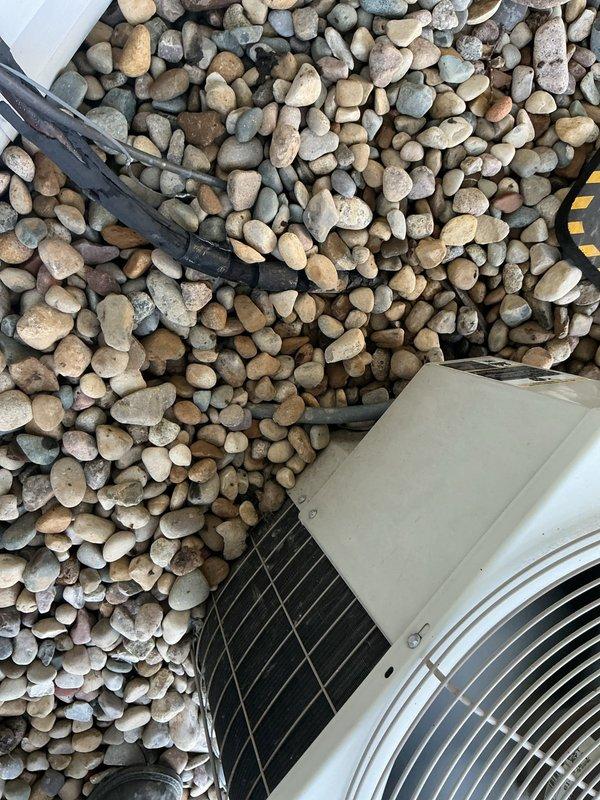 Completed comprehensive ASTU-AC Super Tune-up on 23-year-old Bryant air conditioning system. Performed full system inspection of outdoor condenser unit, verified proper operation of fan motor and compressor, checked refrigerant levels and pressures, cleaned condenser coils, inspected electrical connections and capacitors, and confirmed condensate drainage system functioning correctly. All components operating within manufacturer specifications; unit properly secured on river rock pad with adequate clearance for airflow and service access.