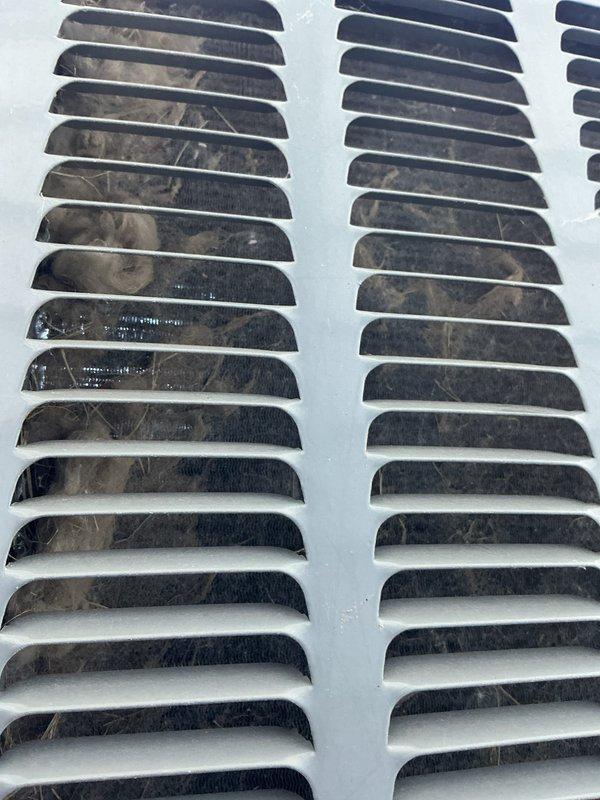 Completed annual cooling maintenance on 2-year-old Payne system (2022 model). Inspected air return vents and grilles, noting significant dust and debris accumulation on louvers and internal fins requiring attention for optimal airflow and system efficiency. Performed standard tune-up procedures to ensure proper operation for the cooling season.