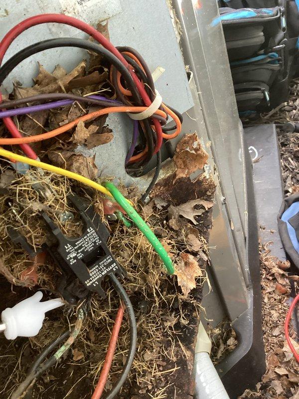 Completed comprehensive AC tune-up on 7-year-old system. Removed heavy accumulation of leaves, pine needles, and organic debris from outdoor condenser unit and electrical components. Cleaned and inspected all electrical connections, including multi-circuit wiring harness and relay components. Verified proper operation of indoor Aprilaire humidifier unit and associated ductwork connections. All system components tested and confirmed operational within manufacturer specifications.