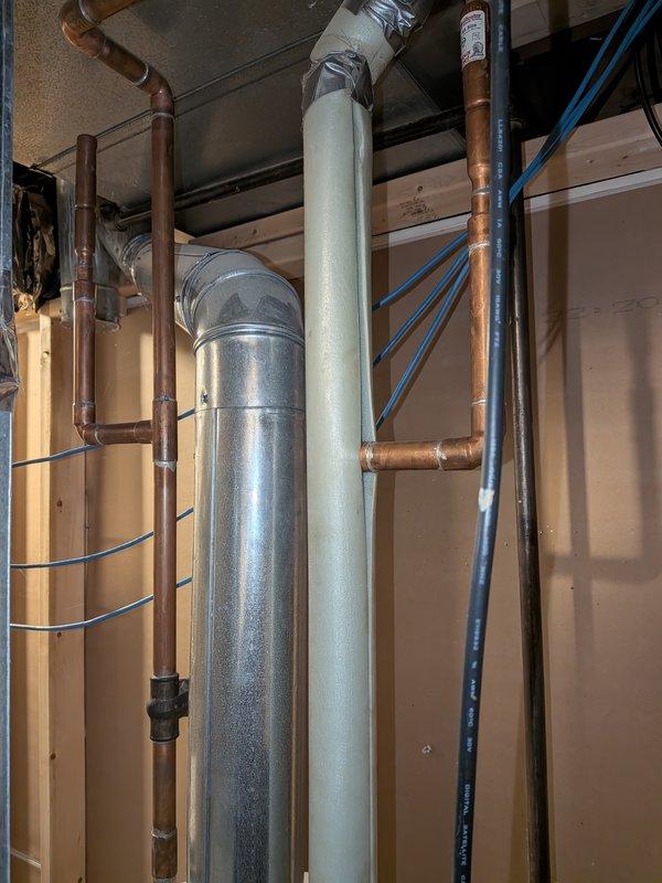 Responded to water heater leak complaint and performed diagnostic inspection of residential water heating system. Upon arrival, conducted visual assessment of mechanical room plumbing infrastructure, including water heater connections, supply lines, and drainage systems. Documented existing conditions of copper supply piping, galvanized ductwork, and associated mechanical components through photographic evidence for service records.