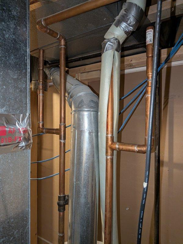 Responded to water heater leak complaint and performed diagnostic inspection of residential water heating system. Upon arrival, conducted visual assessment of mechanical room plumbing infrastructure, including water heater connections, supply lines, and drainage systems. Documented existing conditions of copper supply piping, galvanized ductwork, and associated mechanical components through photographic evidence for service records.