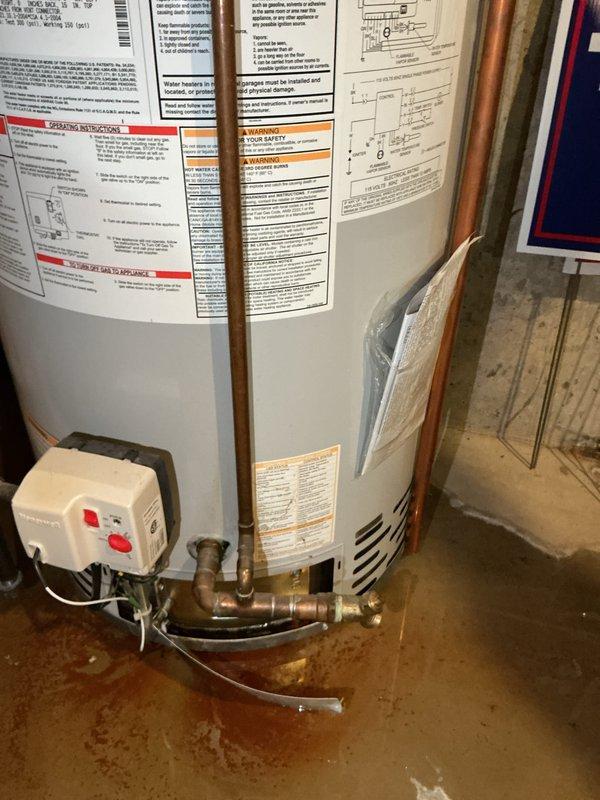 Responded to no hot water complaint on 17-year-old Bradford White water heater. Upon arrival, inspected unit and found evidence of moisture and rust staining on concrete floor at base of tank, indicating active leak from water heater. Evaluated overall condition of unit, noting age and deterioration of components. Documented existing installation with copper supply lines, electrical disconnect, and TPR valve discharge piping. Given the age of the unit at 17 years (beyond typical service life expectancy) and presence of tank leak, advised customer that water heater replacement is necessary as tank leaks cannot be economically repaired. Photographed unit specifications and installation for replacement planning purposes.