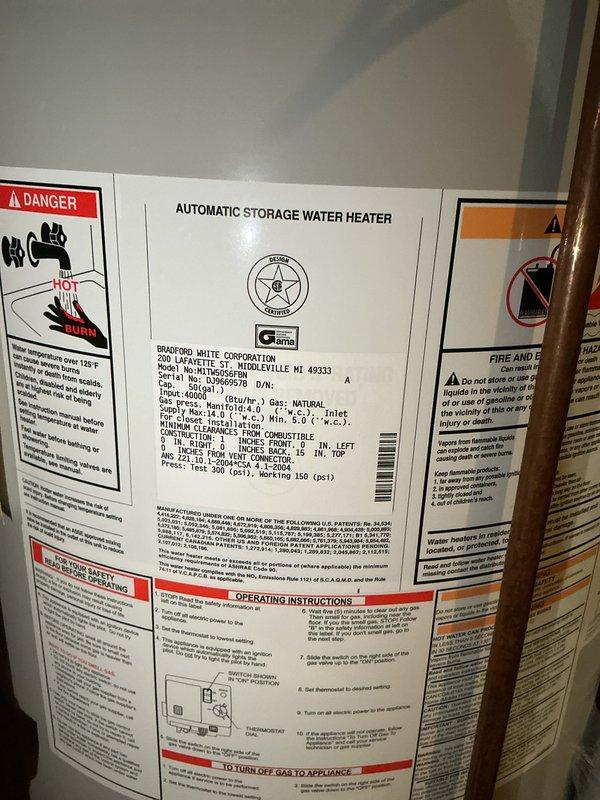 Responded to no hot water complaint on 17-year-old Bradford White water heater. Upon arrival, inspected unit and found evidence of moisture and rust staining on concrete floor at base of tank, indicating active leak from water heater. Evaluated overall condition of unit, noting age and deterioration of components. Documented existing installation with copper supply lines, electrical disconnect, and TPR valve discharge piping. Given the age of the unit at 17 years (beyond typical service life expectancy) and presence of tank leak, advised customer that water heater replacement is necessary as tank leaks cannot be economically repaired. Photographed unit specifications and installation for replacement planning purposes.