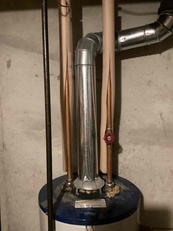 Completed water heater replacement estimate for owner-occupied residence with existing unit over 20 years old. Assessed current installation including copper supply piping, flue venting system, pressure relief valve, and mixing valve configuration in basement utility area. Documented existing equipment condition and provided replacement recommendations per current building codes and manufacturer specifications.