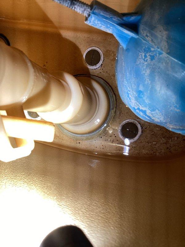 Responded to emergency call for overflowed toilet that caused approximately one inch of water accumulation in basement. Upon arrival, water supply had already been shut off by customer. Performed diagnostic inspection of toilet tank components and flush mechanism to determine cause of overflow for insurance documentation purposes. Inspected fill valve assembly, float mechanism with blue rubber ball float, and flush lever operation. Examined tank interior revealing water staining and mineral deposits indicating age-related wear. Conducted thorough inspection of toilet base mounting and wax ring seal area, identifying potential failure points in plumbing connections. Documented all findings with photographs showing internal tank components, fill valve condition, float assembly operation, and floor flange installation. Provided detailed assessment of toilet system condition and probable causes of overflow incident to support insurance claim determination.