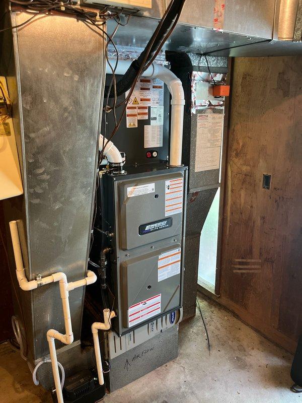 Completed full HVAC system installation in basement utility space. Installed new high-efficiency furnace with proper venting using white PVC piping, connected all necessary ductwork including metallic supply plenum and distribution branches, and established electrical connections with appropriate safety disconnect. System was tested for proper operation, airflow verified, and all manufacturer safety labels confirmed visible and intact.