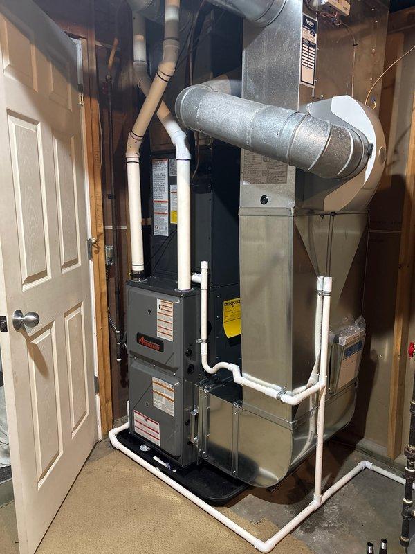 Completed full HVAC system installation including new furnace and air conditioning unit. Installed outdoor condenser unit on concrete pad with proper electrical disconnect and metering, mounted indoor furnace and air handler in utility room with all necessary ductwork connections, condensate drain lines, and PVC venting. All equipment properly wired, piped, and secured per manufacturer specifications and local codes.