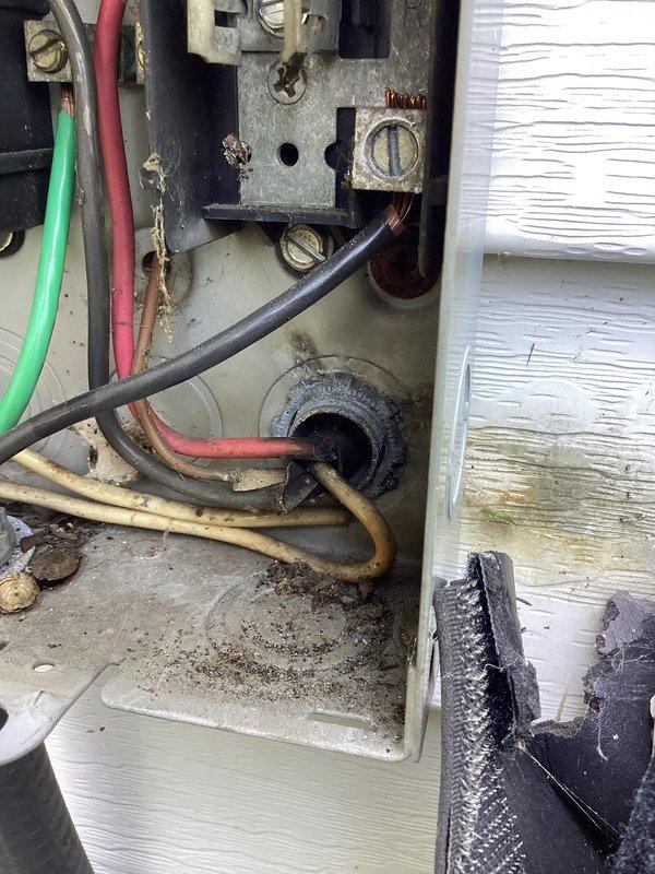 Responded to no cooling complaint on 2024 Trane model MAAC4030D1000AA heat pump system blowing room temperature air. Upon arrival, performed system diagnostics and visual inspection of outdoor unit and electrical connections. Documented existing conditions including weathered electrical service panel with visible corrosion on mounting hardware and terminals, and outdoor condensing unit showing normal exterior wear. System utilizes R410A refrigerant with rated charge of 5 lbs 12 oz, operating on 208/230V electrical service. Captured photographic documentation of equipment nameplate data, electrical connections, and overall unit condition for service records.