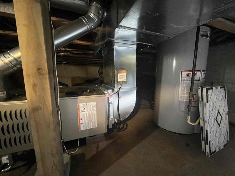 Completed full HVAC system installation including new furnace and air conditioning unit in residential property. Installed gas furnace in basement utility area with proper ductwork connections to existing distribution system, secured unit to manufacturer specifications, and verified all supply and return air pathways. Mounted new condensing unit on exterior concrete pad with proper clearances, ran refrigerant lines and electrical conduit through exterior wall penetration, established sealed connections between indoor and outdoor components, and completed all electrical terminations per code requirements.