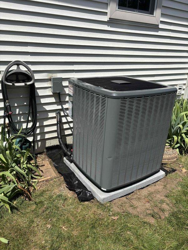 Completed full HVAC system installation including indoor furnace unit with integrated Aprilaire humidifier and outdoor air conditioning condenser. Installed all refrigerant line sets, electrical connections with exterior disconnect box, and complete white PVC condensate drain and venting system throughout basement utility area. Mounted outdoor condenser unit on concrete pad with proper clearances, verified all electrical connections, tested system operation, and ensured proper drainage routing for both heating and cooling components.