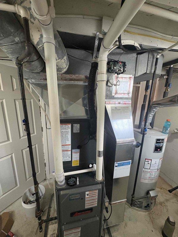 Complete HVAC system replacement performed, including installation of new Luxaire outdoor condensing unit and indoor air handler. Removed existing equipment and installed new outdoor unit on concrete pad with proper refrigerant charge of 54.6 ounces as specified by manufacturer. Connected copper line sets to brass service valves with appropriate service port caps. Indoor air handler installed in utility room with integration to existing ductwork and proper venting configuration using PVC piping. All electrical connections completed to manufacturer specifications. System tested for proper operation, refrigerant levels verified, and all safety labels affixed per code requirements.