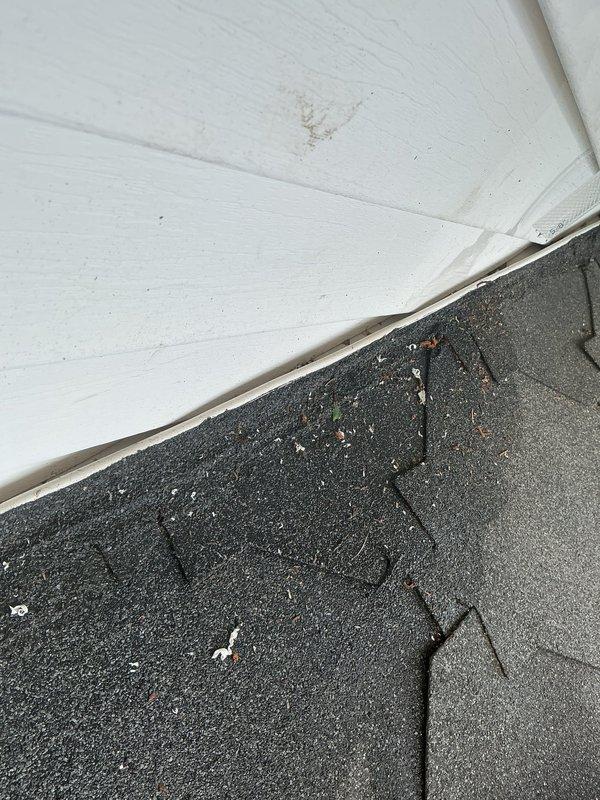 Responded to water leak complaint regarding minisplit head unit in living room draining down interior wall and causing flooding at exterior mailbox location. Upon inspection, identified improper condensate drainage from the indoor air handler unit. Traced condensate line routing from interior unit to exterior discharge point and discovered drainage issue at building envelope penetration where line exits structure. Documented exterior wall and roof junction area showing condensate discharge location and evidence of water intrusion pathway. Recommended proper condensate line installation with appropriate pitch, secure mounting, and verified termination point away from building foundation and mailbox area to prevent future water damage.