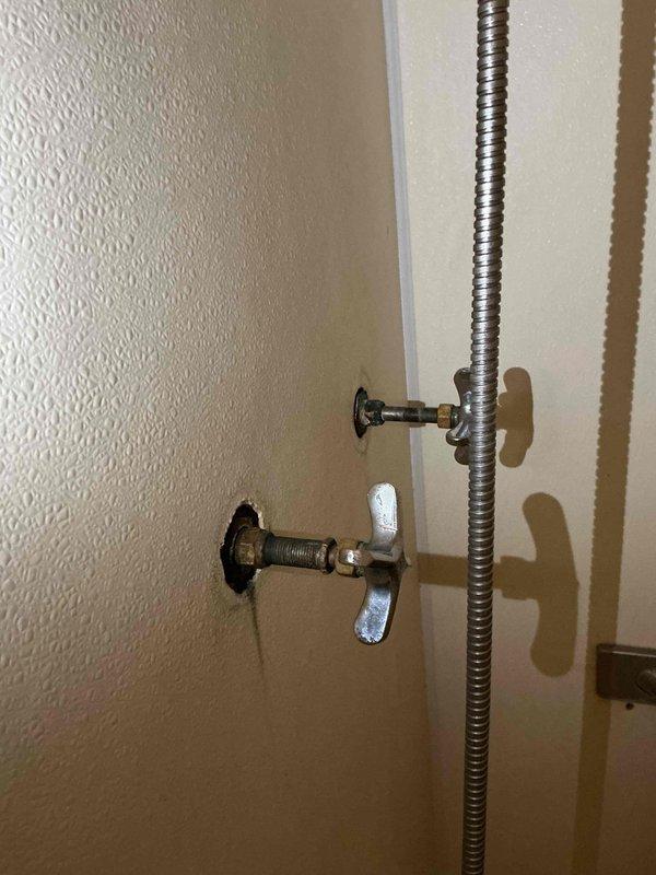Responded to multiple plumbing issues in a 75-year-old residential property including clogged drain, leaky kitchen faucet, leaky bathroom faucet, and shower malfunction that had persisted for several weeks. Inspected basement plumbing infrastructure including aged cast iron drain stack system with multiple branch connections and vertical piping assembly. Cleared drain obstruction using cable auger equipment, repaired both faucet leaks by replacing worn washers and valve components, and addressed shower fixture issue. Documented existing plumbing conditions including vintage cast iron drain system with metal clamps and fittings, exposed joists in basement utility area, and wall-mounted conduit installations. All reported plumbing problems resolved and systems restored to proper working order.
