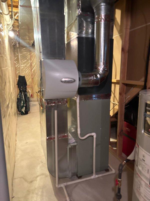 Completed air conditioning system replacement in residential basement mechanical room. Removed existing AC unit and installed new condensing unit with associated refrigerant lines and electrical connections. Verified proper integration with existing furnace and ductwork system, confirmed all electrical connections meet code requirements, and tested system operation to ensure proper cooling cycle and airflow. Unit is fully operational with all safety controls functioning as designed.