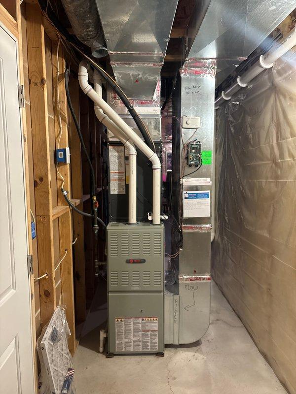 Completed air conditioning system replacement in residential basement mechanical room. Removed existing AC unit and installed new condensing unit with associated refrigerant lines and electrical connections. Verified proper integration with existing furnace and ductwork system, confirmed all electrical connections meet code requirements, and tested system operation to ensure proper cooling cycle and airflow. Unit is fully operational with all safety controls functioning as designed.