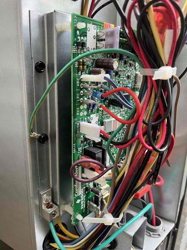Responded to no-cool condition on EnergiAir system affecting entire home. Customer reported unit not activating after being away for one week, with thermostat displaying Wi-Fi/connection-related message. Upon arrival, inspected furnace and control board assembly in basement utility area. Evaluated system wiring connections, control board components, and thermostat communication pathway. Addressed connectivity issue between thermostat and HVAC control board that prevented system operation. Restored proper communication protocol, verified all wire terminations at control board connectors, and confirmed system response to thermostat commands. Cycled system through complete startup sequence to ensure proper operation. Unit now cooling normally with all functions restored.