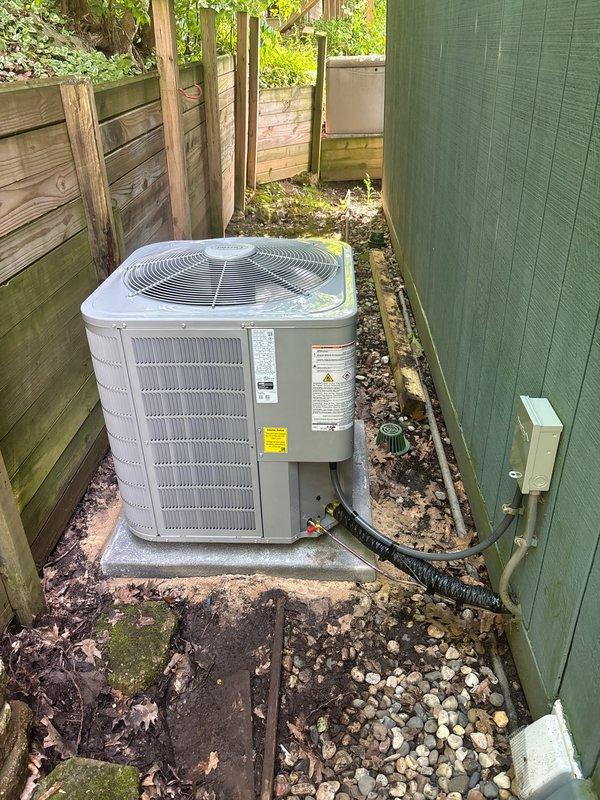 Completed full installation of residential HVAC system including furnace, air conditioning unit, and water heater. Installed Bradford White water heater in basement utility area with copper piping and brass fittings connected to existing plumbing infrastructure along stone foundation wall. Mounted outdoor AC condenser unit on concrete pad in side yard with proper electrical connections, refrigerant lines, and black corrugated conduit running to interior equipment. All units tested and verified operational upon completion of installation.