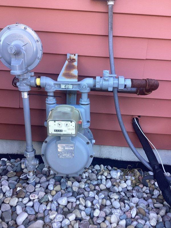 Conducted site assessment for installation of new natural gas line from existing residential meter to detached pole barn structure. Evaluated current gas meter assembly and pressure regulator configuration at main building, documented existing piping conditions including areas of corrosion requiring attention, and surveyed interior pole barn workspace to determine optimal routing path and connection point. Provided comprehensive project estimate including materials, labor, trenching requirements, and necessary permits for underground gas line installation per local code requirements.