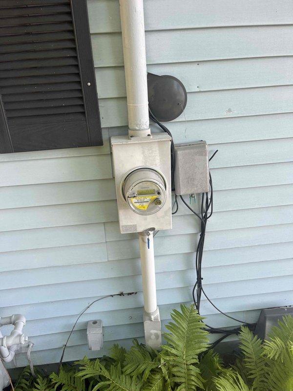 Conducted on-site evaluation for whole house Generac generator installation. Assessed existing electrical infrastructure including exterior meter installation with current service entrance configuration, conduit routing, and available clearances on vinyl-sided exterior wall. Evaluated interior electrical panel location in basement area, documented panel capacity and available space for transfer switch integration, and identified optimal routing paths for generator connection. Photographed existing utility connections, service entrance equipment, and electrical panel setup to develop comprehensive installation estimate and equipment specifications for automatic standby generator system.