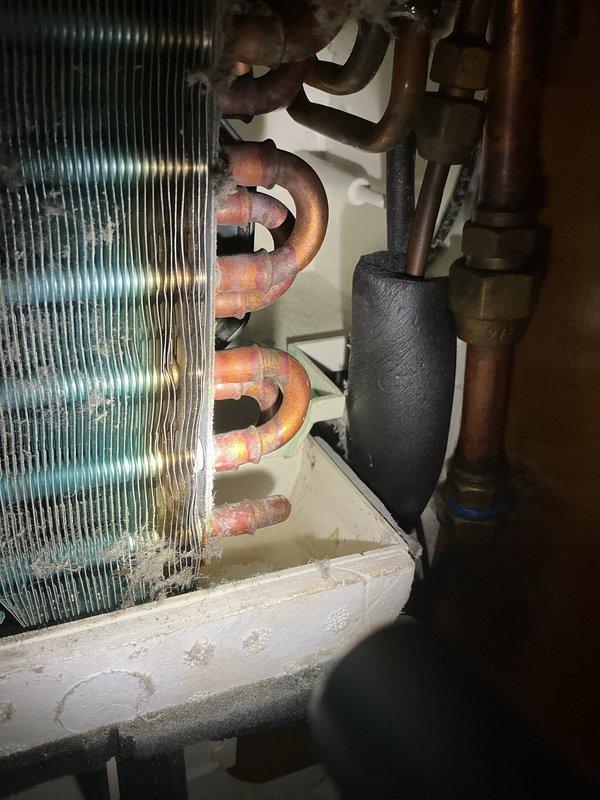 Responded to water leak complaint on 8-year-old Bryant AC unit in bedroom. Upon inspection, found evaporator coil and refrigerant lines showing significant corrosion and oxidation, with condensate drain system plugged as customer suspected. Cleared blocked drain line, inspected drain pan for proper drainage, and verified condensate removal system functioning correctly to resolve water leakage issue.