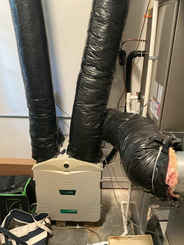 Completed comprehensive AC Super Tune-up on residential system, performing detailed inspection of all mechanical and electrical components within the air handler compartment. Observed evidence of moisture exposure with rust discoloration on the condensate drain pan, noted system age showing general wear on internal components, and verified all electrical connections, refrigerant lines, and motor assembly were functioning properly with no immediate service needs identified.
