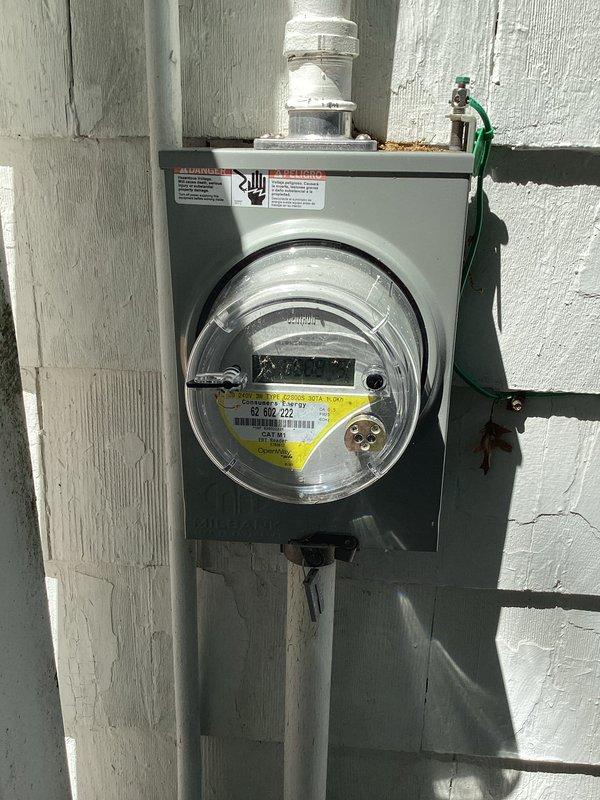 Conducted comprehensive estimate for air conditioning system installation and electrical panel upgrade. Evaluated existing electrical infrastructure, which included outdated electrical panels with exposed circuit breakers, aging wiring configurations, and current meter installation on exterior wall. Assessed electrical capacity requirements for new AC system integration, determining that panel upgrade would be necessary to support additional load demands. Documented existing conditions including legacy electrical boxes with visible wear, seafoam-colored conduit network, and newer beige panel with circuit breaker arrangement. Photographed exterior meter assembly with PVC conduit system and interior utility space showing multiple panel configuration on concrete block wall. Provided detailed recommendations for panel modernization to accommodate air conditioning equipment installation while ensuring compliance with current electrical codes and safety standards.