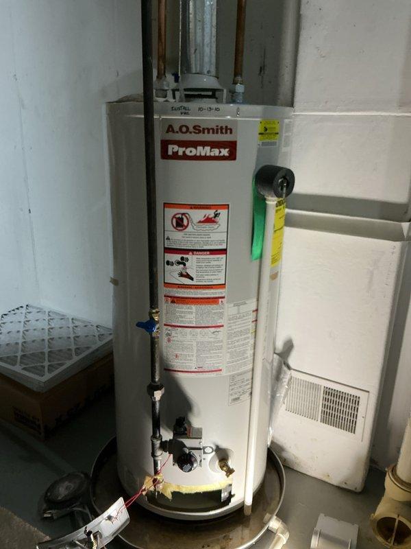 Responded to service call for leaking 15-year-old A.O. Smith ProMax water heater. Upon inspection, found active water leak requiring immediate attention. Due to age of unit and extent of leak, recommended and performed complete water heater replacement to prevent further water damage to basement area.