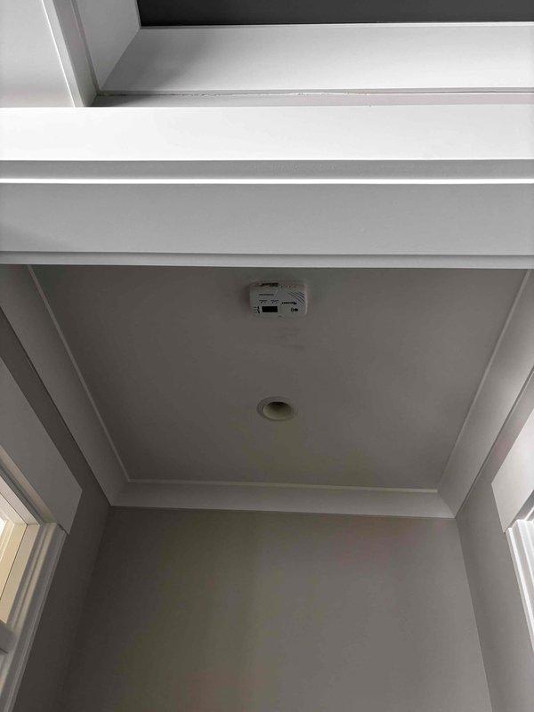 Returned to property to complete previously quoted work. Installed carbon monoxide detector on interior ceiling per code requirements, mounting unit flush in recessed tray ceiling area. Performed comprehensive tune-up on HVAC system, including inspection of condenser unit electrical components, capacitor, wiring connections, and refrigerant lines. Verified all safety systems operational and unit functioning properly.