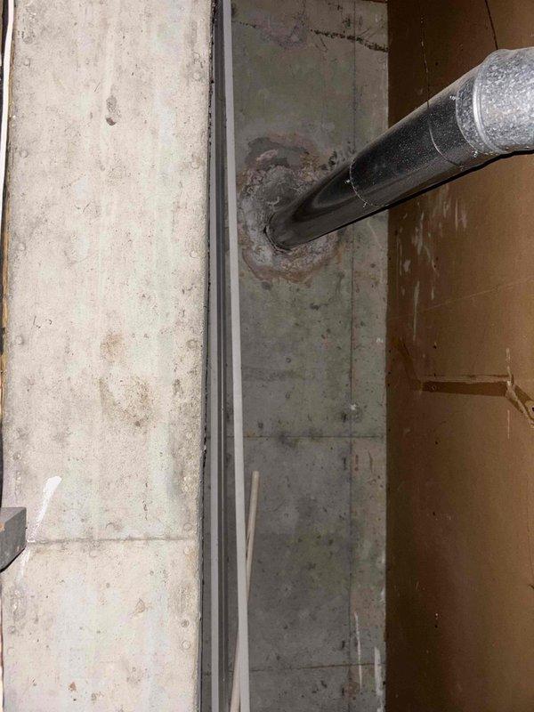 Completed estimate for water heater replacement options at residential property. Evaluated existing Bradford White Defender Safety System tank-style water heater installation in basement utility area, documenting current equipment configuration including copper supply piping, blue-handled shutoff valve, and flexible vent ductwork penetrating exterior wall. Assessed installation location with exposed wall framing and provided pricing options for both traditional tank-style and tankless water heater systems to meet customer requirements.