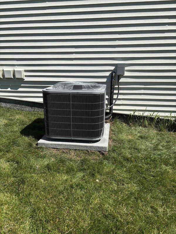 Completed full HVAC system installation including new furnace and air conditioning condenser unit. Furnace installed in basement utility area with proper ductwork connections and venting configured. AC condenser unit positioned on concrete pad in exterior location with electrical conduit properly routed along building exterior. All refrigerant lines connected between indoor and outdoor components. System tested for proper operation, airflow verified, and installation documented with photographs showing completed equipment placement and final configuration.