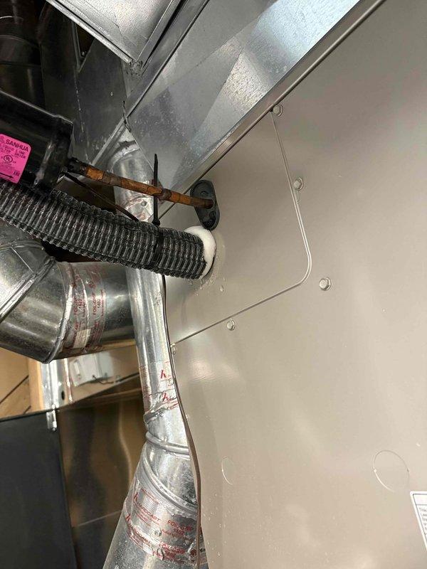 Responded to air conditioning system not cooling to set temperature. Inspected indoor air handler unit and outdoor condensing unit. Evaluated system components including ductwork connections, refrigerant lines, and electrical conduits. Documented equipment condition with photos showing indoor mechanical components and outdoor unit installation. System is under 2-year parts warranty coverage extending through June 2028.