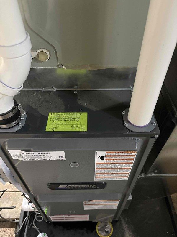 Responded to no cooling complaint on residential air conditioning system. Upon arrival, performed visual inspection of indoor air handler and outdoor condensing unit. Documented significant rust and corrosion present on refrigerant line connections at outdoor unit, indicating prolonged exposure to weather and moisture. Flange connection showed heavy oxidation with visible deterioration that could compromise system integrity. Indoor air handler inspection revealed unit in utility area with proper condensate drain lines installed. Photographed corroded components and equipment labels for documentation purposes. System age could not be determined from available information. Recommended further diagnostic evaluation to assess refrigerant line integrity, check for potential leaks at corroded connections, and determine full extent of repairs needed to restore cooling capacity.