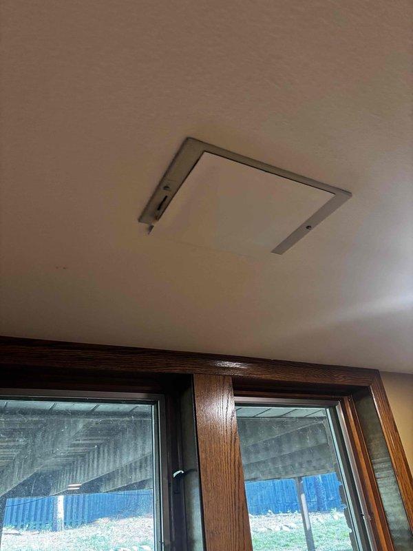 Responded to no cooling complaint and performed system inspection. Upon arrival, found ceiling-mounted air handler access panel improperly secured. Inspected unit through access opening, checked refrigerant levels, electrical connections, and airflow. Secured access panel properly to ensure adequate return air pathway and prevent system inefficiency. Verified unit operation and confirmed cooling restored to normal parameters.