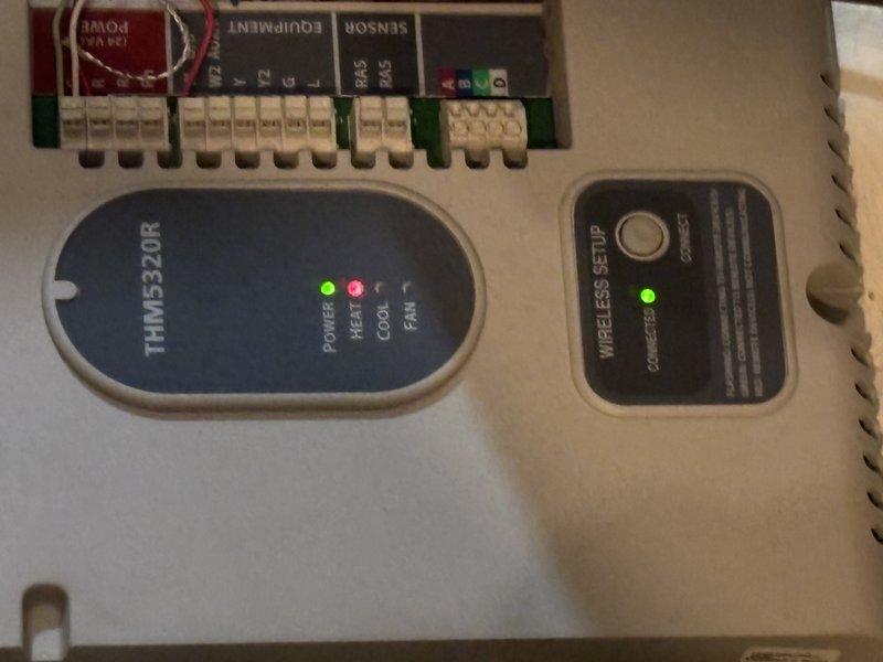 Responded to service call for water heater experiencing extended heating times on aging 25-30 year old Burnham unit. Upon inspection, evaluated the electronic control system and verified proper operation of control board components, including power indicators and heating elements. Documented existing HVAC control panel configuration showing active status lights on TRIME320R module and wireless setup interface, confirming electrical connections at terminal blocks were secure. Assessed complete mechanical and electrical installation including circuit protection devices, control panels, junction boxes, and associated conduit runs to ensure system integrity and proper communication between components.