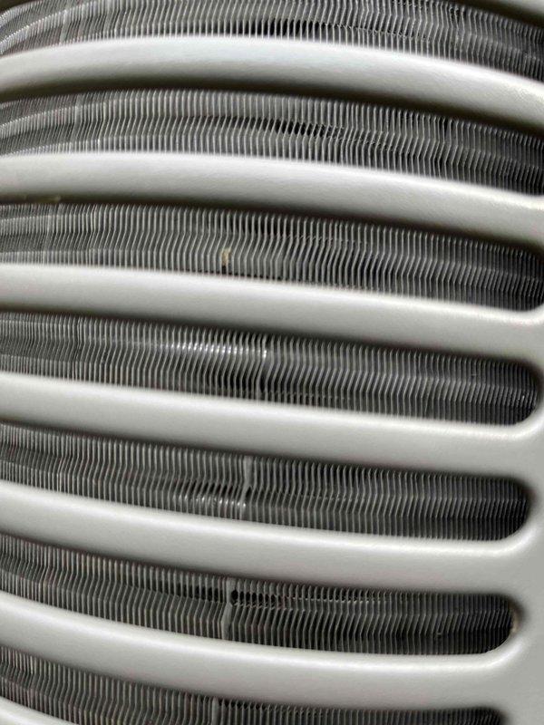 Completed annual cooling maintenance on a 9-year-old air conditioning system. Inspected condenser coil fins and heat exchanger components, which showed normal wear with minor dust accumulation but remained in serviceable condition. All system components were photographed for documentation, and unit was confirmed operational with no immediate repairs required.