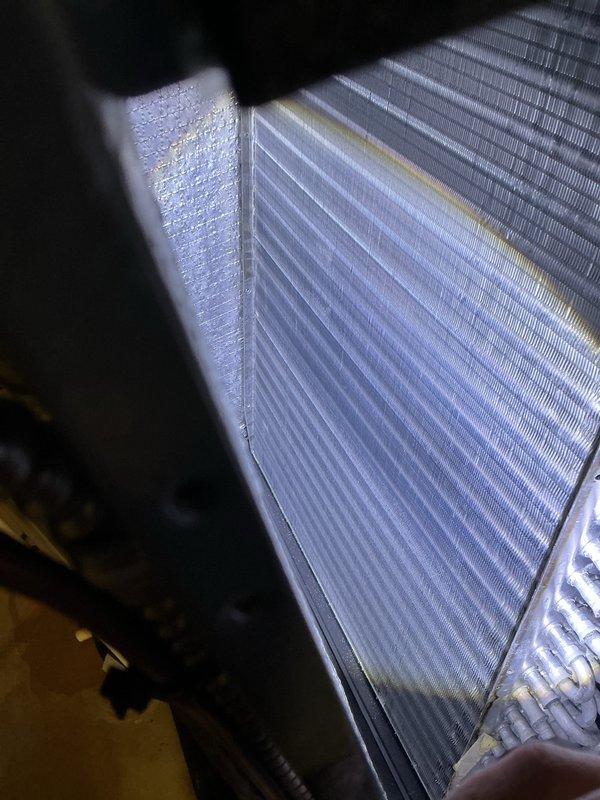 Completed comprehensive AC Super Tune-up on residential HVAC system. Performed thorough inspection of evaporator coil assembly, confirming clean metallic fins with proper spacing and no visible debris accumulation. Verified refrigerant lines, heat exchanger components, and protective screening are in good operating condition with no signs of corrosion or damage.