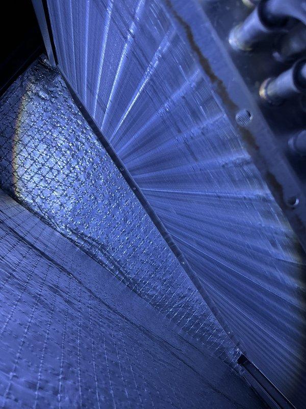 Completed comprehensive AC Super Tune-up on residential HVAC system. Performed thorough inspection of evaporator coil assembly, confirming clean metallic fins with proper spacing and no visible debris accumulation. Verified refrigerant lines, heat exchanger components, and protective screening are in good operating condition with no signs of corrosion or damage.