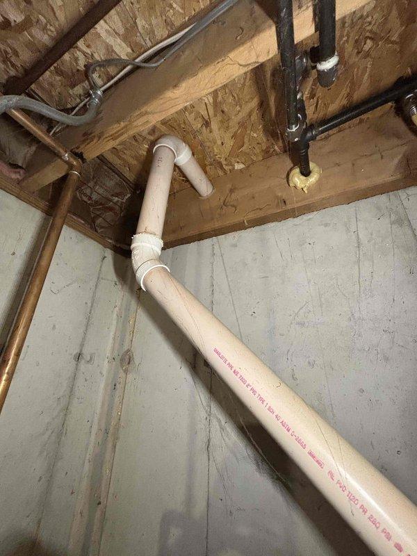 Provided estimate for water heater replacement on 23-year-old unit that has reached end of service life. Assessed existing installation in unfinished basement utility area, documenting current plumbing configuration including copper supply lines, PVC venting system, and connections to existing water treatment equipment. Recommended replacement to ensure continued reliable hot water delivery and prevent potential failure of aging equipment.