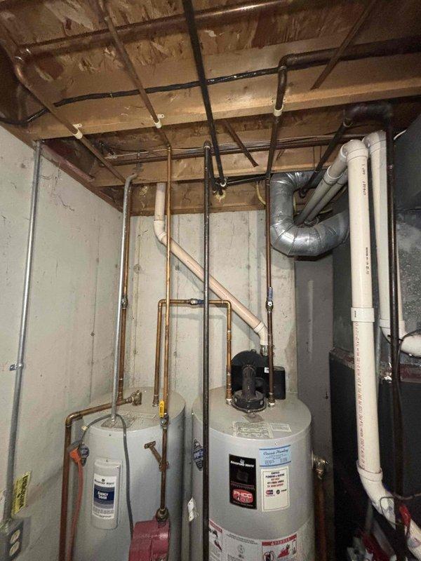 Provided estimate for water heater replacement on 23-year-old unit that has reached end of service life. Assessed existing installation in unfinished basement utility area, documenting current plumbing configuration including copper supply lines, PVC venting system, and connections to existing water treatment equipment. Recommended replacement to ensure continued reliable hot water delivery and prevent potential failure of aging equipment.