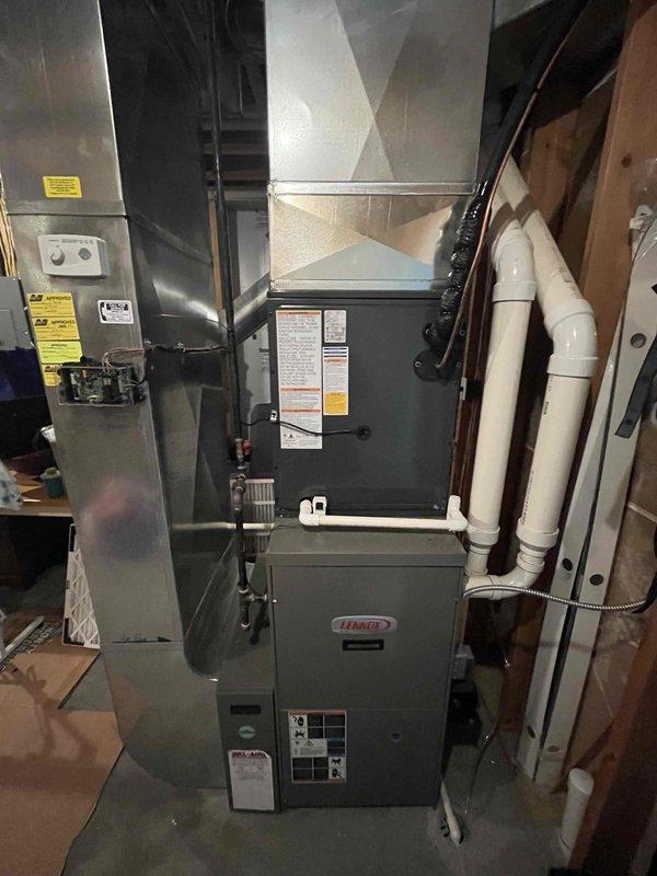 Completed full HVAC system replacement including installation of new Lennox furnace and air handler in basement utility area. Installed two exterior condensing units on concrete pad with proper refrigerant line sets, electrical conduit, and PVC condensate drain lines. All ductwork connections secured, system tested and verified operational per manufacturer specifications.