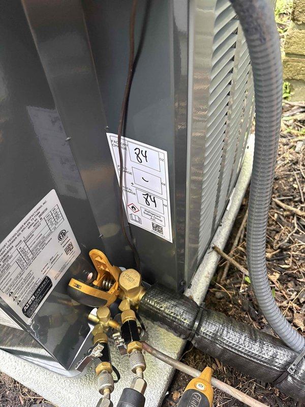 Completed full air conditioning system replacement including outdoor condensing unit and indoor air handler. Installed new outdoor unit on existing pad with proper refrigerant line connections, verified all electrical connections, and charged system to manufacturer specifications using digital manifold gauges. Installed new air handler in utility room with updated PVC venting configuration routed through ceiling space. System tested and operational upon completion.