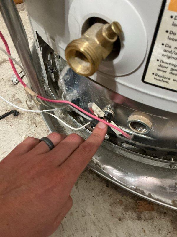 Responded to no hot water complaint on 12-year-old Bradford White water heater affecting entire home. Upon inspection, examined electrical connections and components at base of unit, including wiring terminals and control systems. Assessed water heater condition, verified age and model specifications, and documented equipment status with detailed photographs of electrical connections, plumbing fittings, safety labels, and overall installation. Evaluated brass water connections, copper piping, circulation pump assembly, and emergency shutoff valve. Customer provided contact information for follow-up communication regarding findings and recommendations.