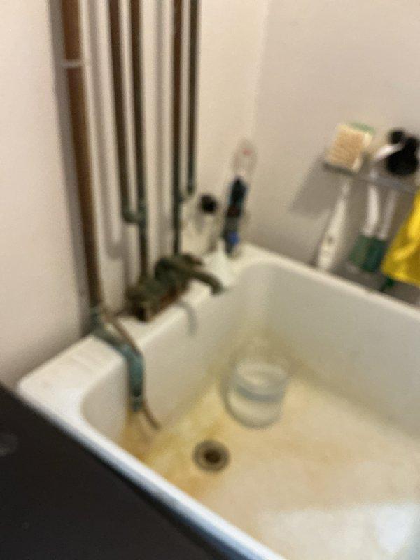 Responded to service call for multiple plumbing issues in a 1979-built residence, including four leaking faucets and one malfunctioning drain. Inspected bathroom sink with wall-mounted faucet assembly and kitchen double-basin stainless steel sink with pull-down sprayer. Addressed long-standing leak conditions, with the oldest leak having persisted for approximately ten years. Performed necessary repairs to restore proper function to all affected fixtures, eliminating water waste and preventing further damage. Documented conditions with photographs for service records.