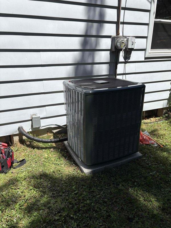 Completed full air conditioning system replacement at residential property. Installed new outdoor condenser unit on exterior grade with proper refrigerant line routing and electrical disconnect. Replaced indoor air handler with new unit, integrated with existing furnace system in basement utility area. Established refrigerant line connections between indoor and outdoor components, verified proper ductwork integration, and ensured all electrical connections meet code requirements.
