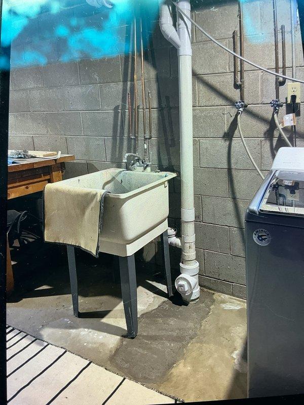 Replaced 3 feet of deteriorated cast iron drain pipe in an outdoor utility area. Excavated and removed failed section, tied in new PVC piping to existing underground drainage system, and rebuilt vertical drain stack above ground level using PVC components with proper fittings and transitions.