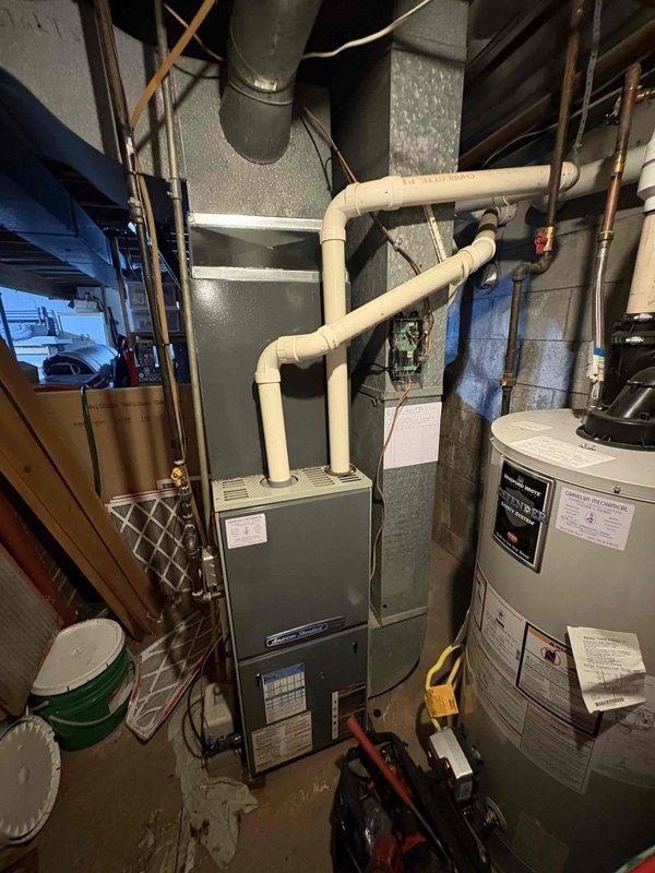 Completed full air conditioning system replacement in residential basement mechanical room. Removed existing AC unit and installed new condensing unit with proper refrigerant line connections, electrical hookups, and integration with existing furnace and ductwork system. Verified all connections, tested system operation, and confirmed proper airflow and temperature differential upon completion.